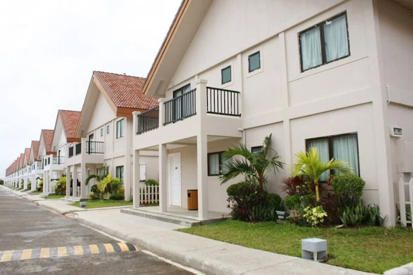 Two-storey villa facades along the garden path