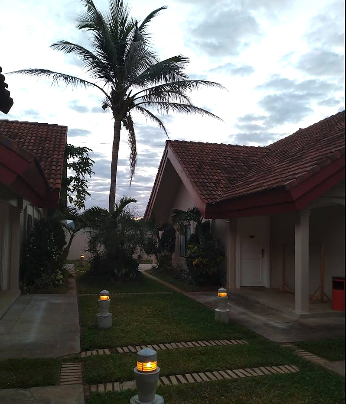 Villas at dusk lit by garden lanterns