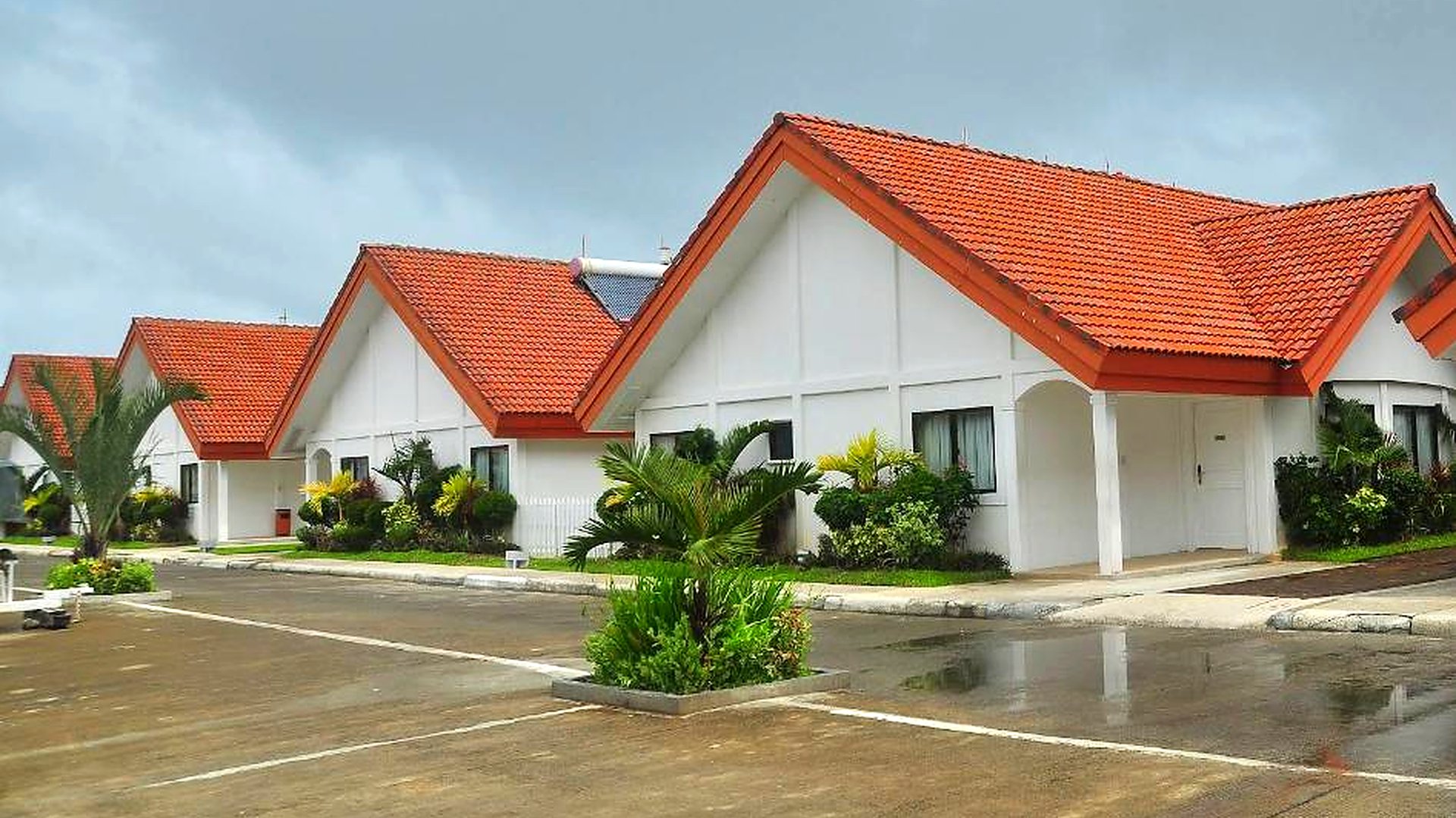 Row of Northern Hotel villas with red tiled roofs and white walls
